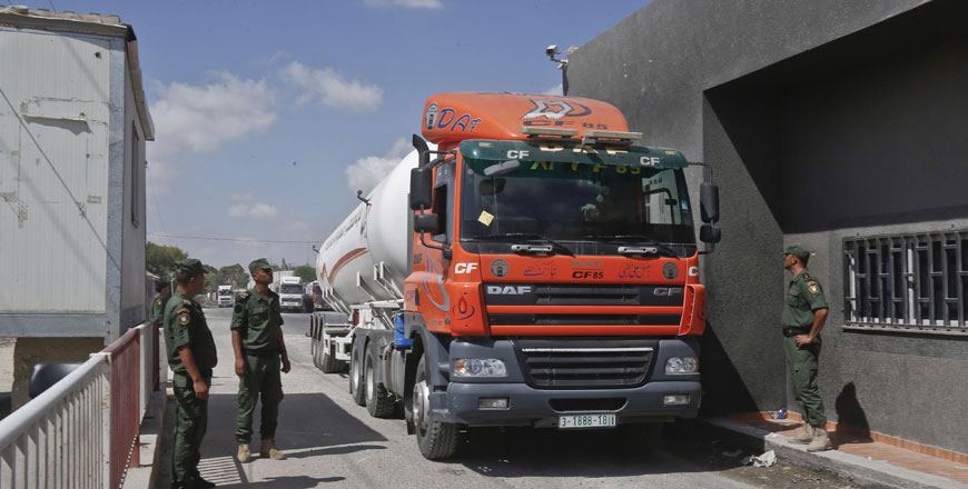 Members of Palestinian security forces watch as a fuel tanker arrives at Kerem Shalom crossing in Rafah in the southern Gaza Strip on Wednesday (AFP photo)