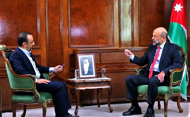 Prime Minister Omar Razzaz speaks during an interview with Jordan Television to discuss the teachers’ strike on Tuesday (Petra photo)