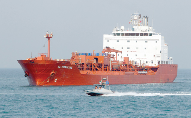 In this file photo taken on July 2, 2012, Iranian Revolutionary Guards drive speedboats in front of an oil tanker during a ceremony to commemorate the 24th anniversary of the downing of Iran Air flight 655 by the US navy, at the port of Bandar Abbas (AFP photo)