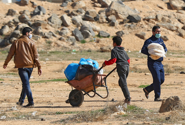A Syrian refugee pushes a wheelbarrow at the Zaatari refugee camp, 80 kilometres north of the capital Amman, on Monday (AFP photo)