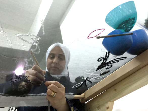 A woman makes custom jewellery in Amman recently as part of an initiative that introduces Jordanians to traditional Syrian products (Photo by Muath Freij)