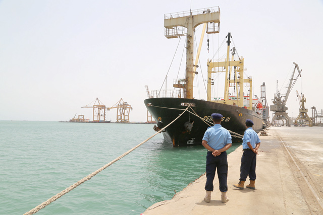 Yemeni coast guards look on at Saleef Port in the western Red Sea Hodeida province after their redeployment following the withdrawal of Houthi rebel fighters on Monday  (AFP photo)
