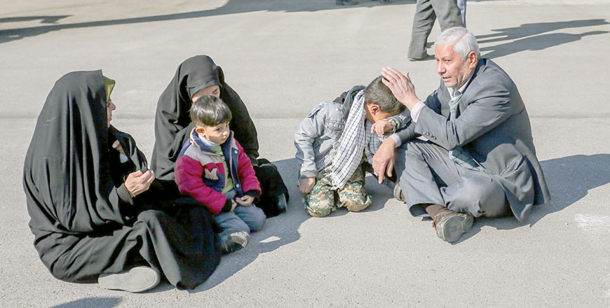 In this photo provided by Tasnim News Agency, relatives of members of Iran's elite Revolutionary Guards, who were killed by a suicide car bomb, mourn at Isfahan airport, Iran, on Thursday (Reuters photo)