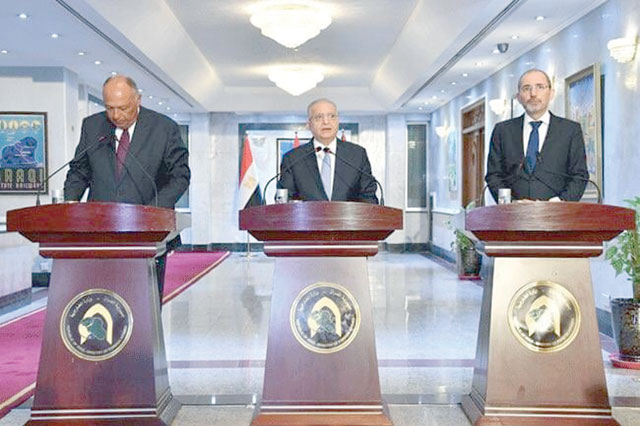 Foreign Minister Ayman Safadi and his Egyptian and Iraqi counterparts Sameh Shukri and Mohammad Hakim speak to the press following a meeting in Baghdad on Sunday (Photo courtesy of Foreign Ministry)