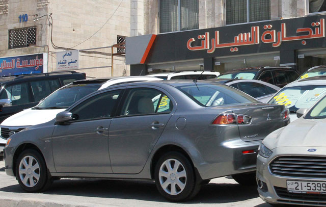 Vehicles are parked near a car dealer shop in Amman's Sports City area recently (Photo by Hassan Tamimi)