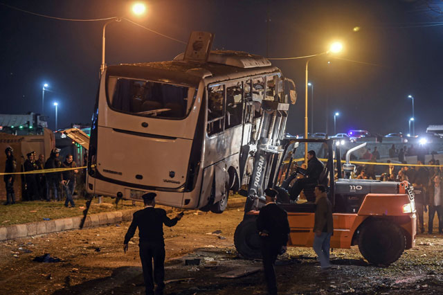 This photo shows a tourist bus which was attacked being towed away from the scene, in Giza province south of the Egyptian capital Cairo, on Friday (AFP photo)
