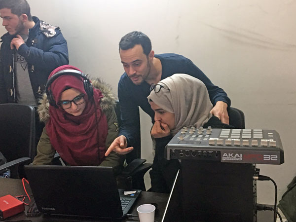 Participants in the Wameed initiative work on their recorded tracks during a recent session (Photo by Sawsan Tabazah)