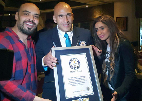 A judge from the Guinness Book of World Records awards radio presenters Amjad Hijazeen and Jessy Abu Faysal a certificate for breaking the record for the longest live radio show hosted by a team last week (Photo courtesy of Amjad Hijazeen)