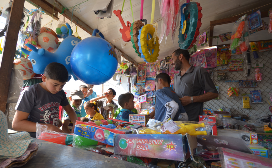 Children at the Zaatari Refugee Camp, some 90km northeast of Amman, spend the first day of Eid Al Fitr shopping for toys and playing outside (Photo by Muath Freij)