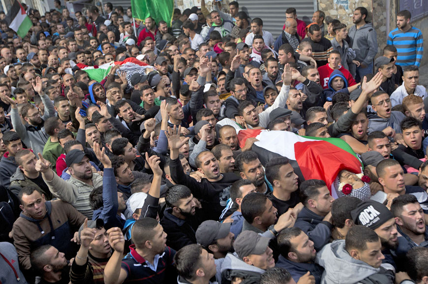 Palestinians carry the bodies of Ahmed Al Ayeh, 28, and Laith Manasra, 21, during their funeral in the Qalandia refugee camp on the outskirts of the West Bank city of Ramallah, on Monday (AP photo)