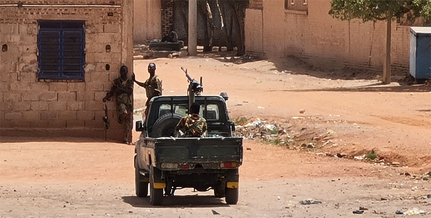 Sudanese army soldiers rest next to a building in Khartoum on Thursday (AFP photo)