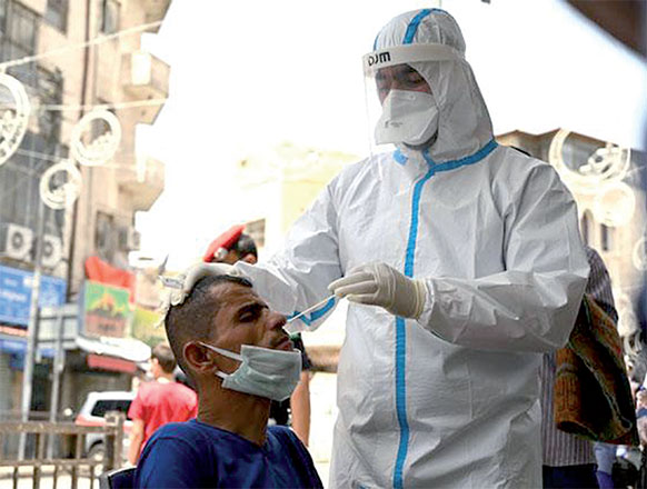 A healthcare worker uses a swab to collect sample from a man during a random coronavirus test in Amman in these recent photograph (JT file photo)