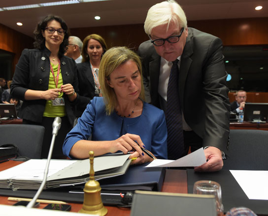High representative of the Union for Foreign Affairs and Security Policy Federica Mogherini (left) talks with German Foreign Minister Frank-Walter Steinmeier during a foreign affairs meeting at the EU headquarters in Brussels on Monday (AFP photo)