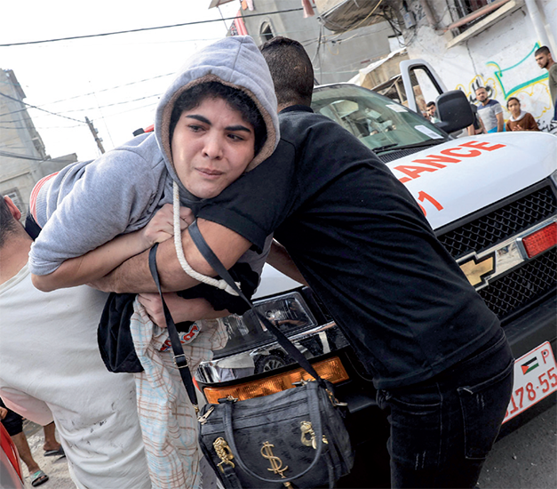 People carry away an injured woman following Israeli bombing on Rafah in the southern Gaza Strip, on Saturday (AFP photo)