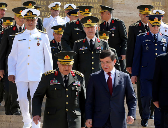 Turkey's Prime Minister Ahmet Davutoglu (right) walks with Chief-of-Staff Gen. Necdet Ozel (left) and other top military commanders, members of the country's high military council, following a visit at the mausoleum of modern Turkey's founder Mustafa Kemal Ataturk, in Ankara, Turkey, on Monday. Turkey’s high military council holds its annual meeting to decide on promotions, retirements and dismissals within the military. This year, the council is expected to appoint Land Forces Commander Gen. Hulusi Akar as chief of general staff to replace Ozel who retires later this month (AP photo)