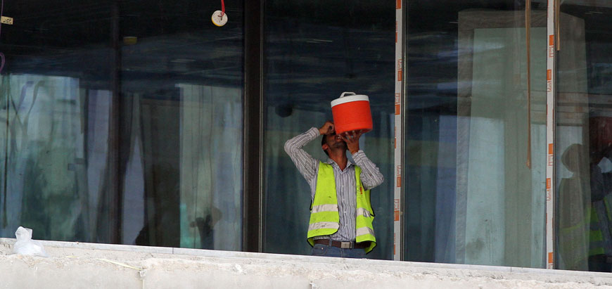 A worker drinks water at a construction site in Amman earlier this week. People are urged to remain hydrated during heatwaves (Photo by Osama Aqarbeh)