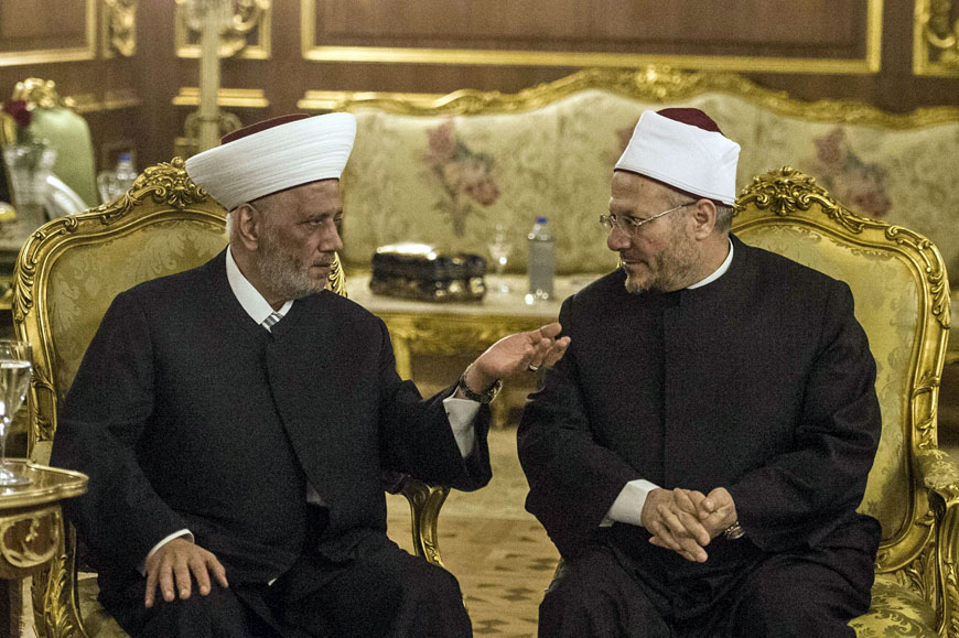 Shawki Ibrahim Abdel Karim Allam (right), the Grand Mufti of Egypt, speaks with Lebanon’s Grand Mufti Sheikh Abdul Latif Derian during the opening session of the Fatwa International Conference, attended by Arab Islamic clerics, in Cairo on Monday (AFP photo)