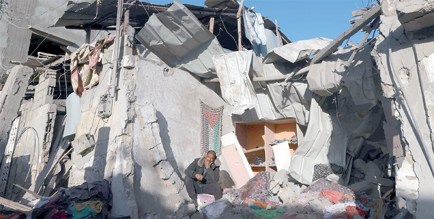A Palestinian man gestures as he sits on rubble of a building following Israeli bombardment, on Thursday in Rafah in the southern Gaza Strip (AFP photo)