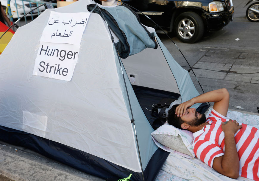 Waref Suleiman, a Lebanese activist, holds a hunger strike with other activists outside the environment ministry in downtown Beirut, Lebanon, Thursday (AP photo)