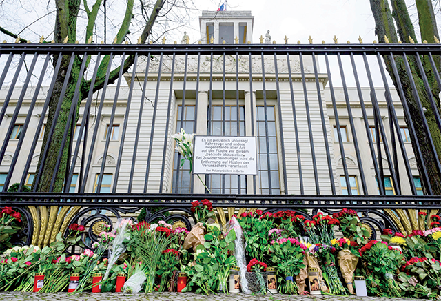 Flowers, candles and pictures lay at an improvised memorial outside the Russian embassy in Berlin on Sunday (AFP photo)