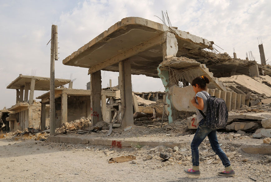 Syrian children walk past debris while heading to school on the second day of the new school year on Tuesday in the Syrian Kurdish town of Kobani. Kurdish forces expelled Daesh jihadists from Kobani in January 2015 with aerial support from the US-led international coalition fighting the radical group (AFP photo)