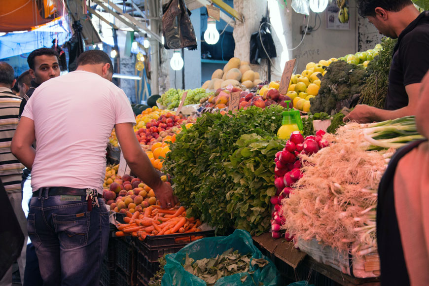In this recent photo, consumers shop for vegetables at a market in Amman (Photo by Amjad Ghsoun)