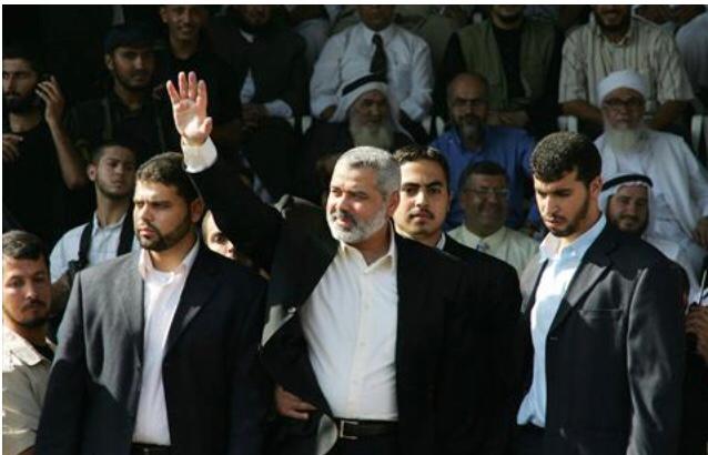 Palestinian Prime Minister Ismail Haniyeh waves to Hamas supporters during a rally in Gaza City, 6 October 2006