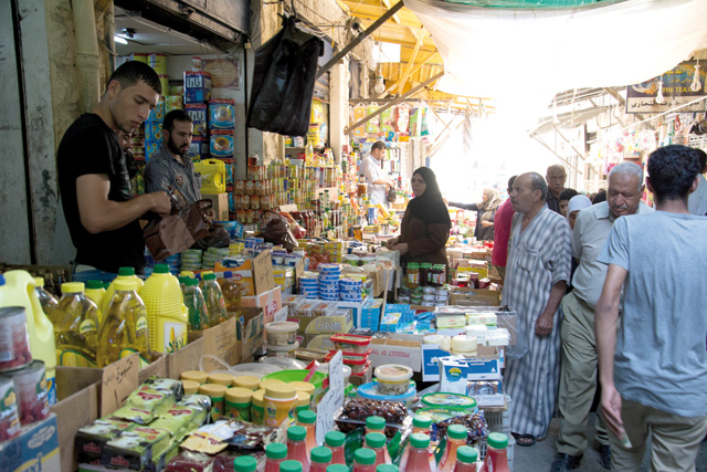In this recent photo, people shop for food supplies in Amman, which has been ranked the most expensive Arab city by the Economist (Photo by Amjad Ghsoun)