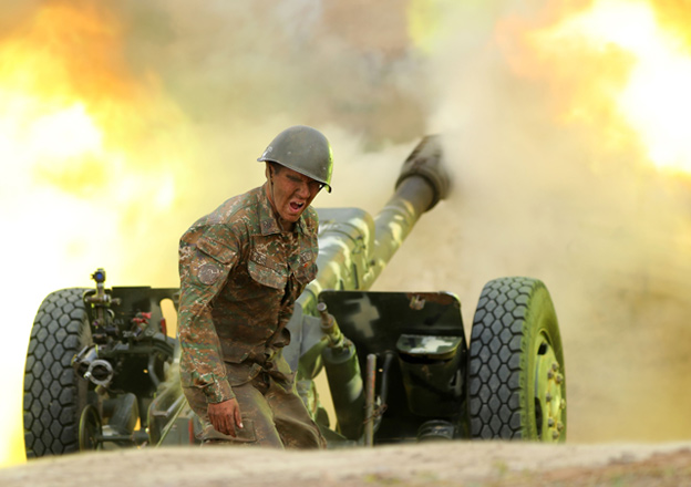 A serviceman of Karabakh's defence army fires an artillery piece towards Azeri positions during fighting over the breakaway Nagorny Karabakh region on Monday (AFP photo)