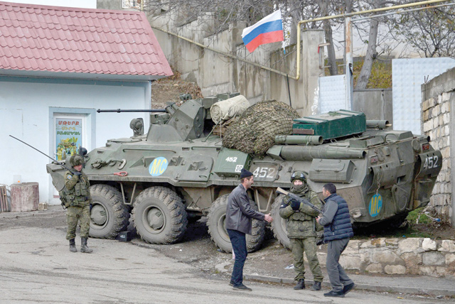 Men interact with a Russian peacekeeper in the town of Lachin (called Berdzor by the Armenians) on November 30 (AFP photo)
