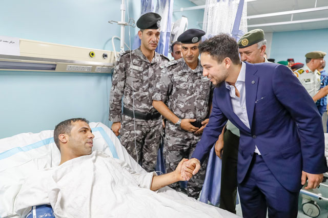 HRH Crown Prince Hussein checks on a security officer injured during protests in Amman on Thursday (Photo courtesy of Royal Court)