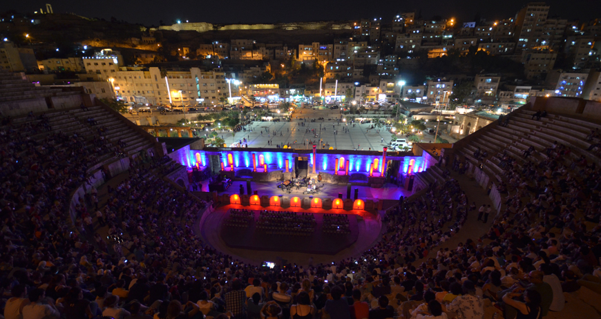 Jordanians and visitors attend a concert by Dhafer Youssef at the Roman Theatre in Amman on Monday (Photo by Muath Freij)