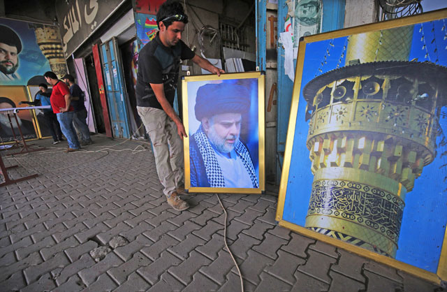 An Iraqi labourer works on a poster of Shiite cleric Moqtada Sadr at a printing shop in Sadr City, east of the Iraqi capital Baghdad, on Wednesday (AFP  photo)