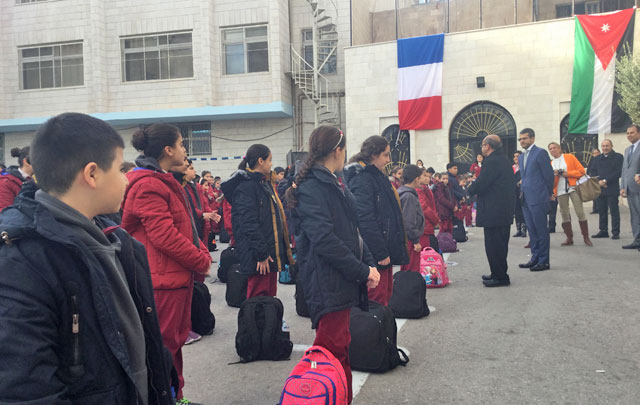 French ambassador to Jordan David Bertolotti and representative of Messengers of Peace Jordan Father Khalil Jaar deliver a speech to the Iraqi refugee children at the school of the Latin Patriarch in Marka on Tuesday (Photo courtesy of French embassy)