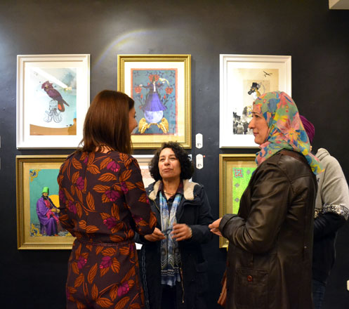 Artist Zeina El Said (left) speaks to visitors of the 'Conference of the Birds' duo exhibition at Jacaranda Gallery in Amman (Photo by Yasmeen Kanaan)