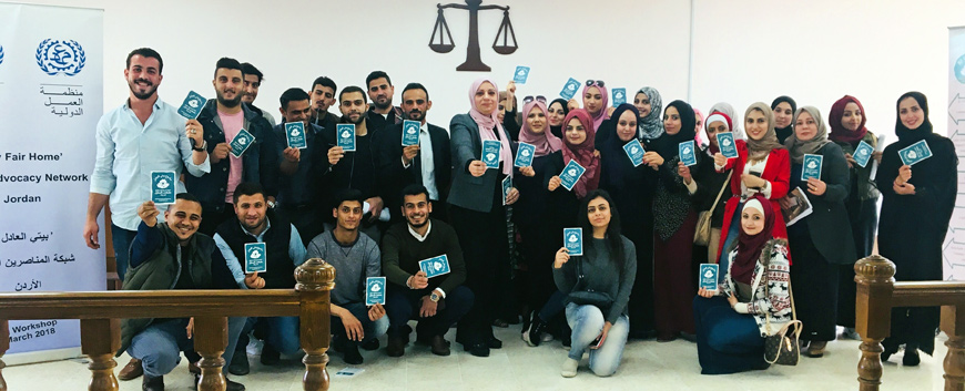 Law students raise the pledge after the lecture held on Domestic workers rights at Yarmouk University on Tuesday (Photo by Sawsan Tabazah)