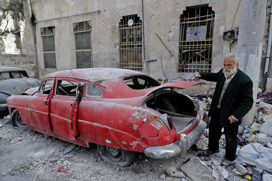 A photo taken on Thursday shows 70-year-old Mohammed Mohiedine Anis opening the trunk of his 1949 Hudson Commodor outside his home in Aleppo’s formerly rebel-held Al Shaar neighbourhood (AFP photo)