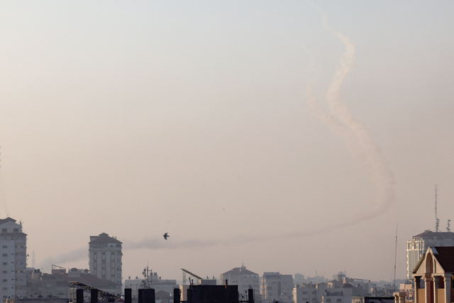 Trails of smoke are seen as rockets are fired from Gaza towards Israel, in Gaza City, on Tuesday (AFP photo)