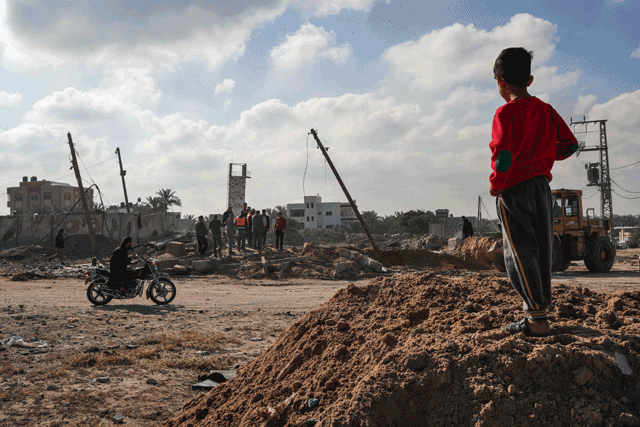 A Palestinian boy checks the site of an air strike targeting a military site in Deir Al Balah, in the central Gaza Strip, on Wednesday, following a flare-up between the Israeli military and Gaza fighters (AFP photo)