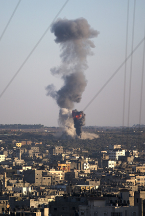Tall plumes of smoke rise from an Israeli missile strike in Gaza City on Wednesday (AP photo)
