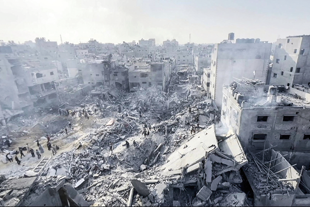 This image grab taken from AFPTV video footage shows Palestinians checking the destruction in the aftermath of an Israeli strike on the Jabalia refugee camp in the Gaza Strip, on Wednesday (AFP photo)