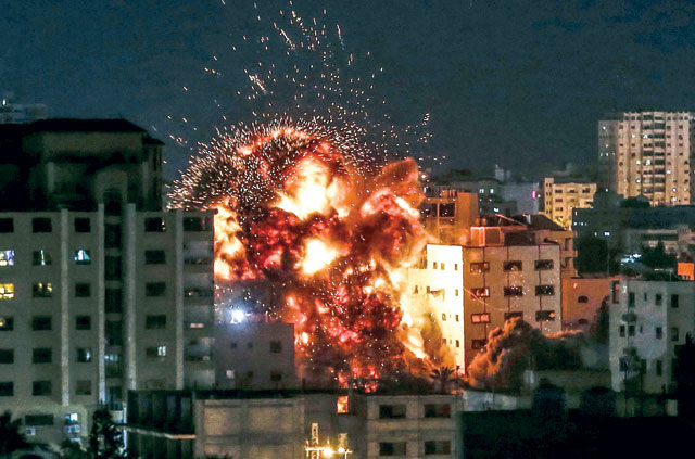 An explosion is pictured among buildings during an Israeli air stike on Gaza City on May 4 (AFP photo)