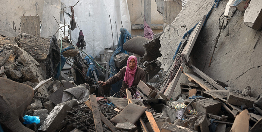 A woman stands beside the debris of a destroyed building following an Israeli air strike on Bureij camp for Palestinian refugees in the central Gaza Strip on January 6, 2025 (AFP photo)