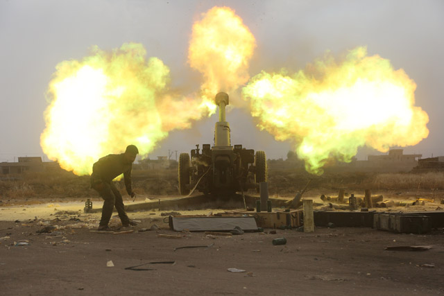 Popular Mobilisation Forces fire towards Daesh militants during a battle on the outskirts of Al Ba'aj, west of Mosul, Iraq, on Friday (Reuters photo)