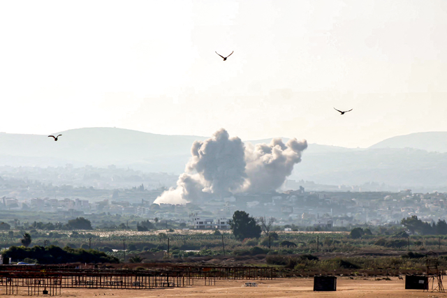 Birds fly away as a smoke cloud erupts following an Israeli air strike on a village near Lebanon's southern city of Tyre on October 9, 2024 (AFP photo)