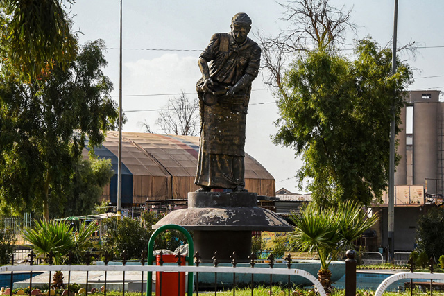 This photo taken on August 29 shows the statue of Al Sawas, which in English means The Licorice Man, and depicts a street peddler selling juice and candy made from the plant, in the northern Iraqi city of Mosul (AFP photo)