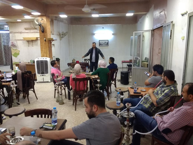 A storyteller performs in front of a mixed audience at the Central Café in Amman recently (Photo courtesy of Sally Shalabi)