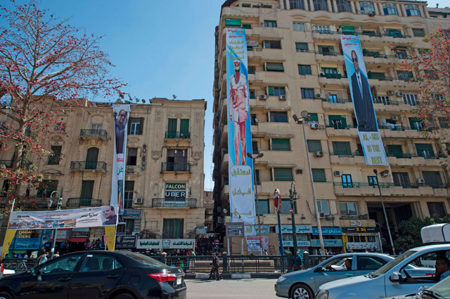 This photo taken on Wednesday shows giant election campaign posters supporting Egyptian President Abdel Fattah Al Sisi in the upcoming presidential election in central Cairo (AFP photo)