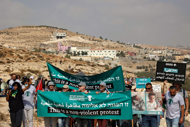 Palestinian demonstrators and Israeli activists, from the Combatants for Peace movement, attend a demonstration against Israeli land confiscation and the cutting of water supply for Palestinian villages, in the southern area of the West bank town of Hebron, on Saturday (AFP photo)