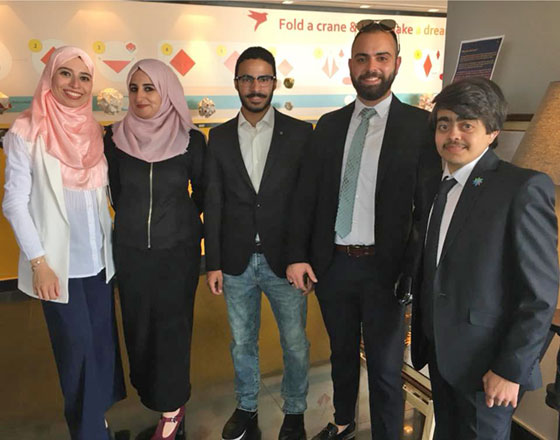 Faisal Isleem (far right) poses for a group photo with amputee artist Abdo Naseif (2nd right)  and fellow exhibitors at the exhibition opening recently  (Photo courtesy of Waragami’s Facebook page)